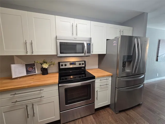 a bathroom with a granite countertop sink mirror and shower