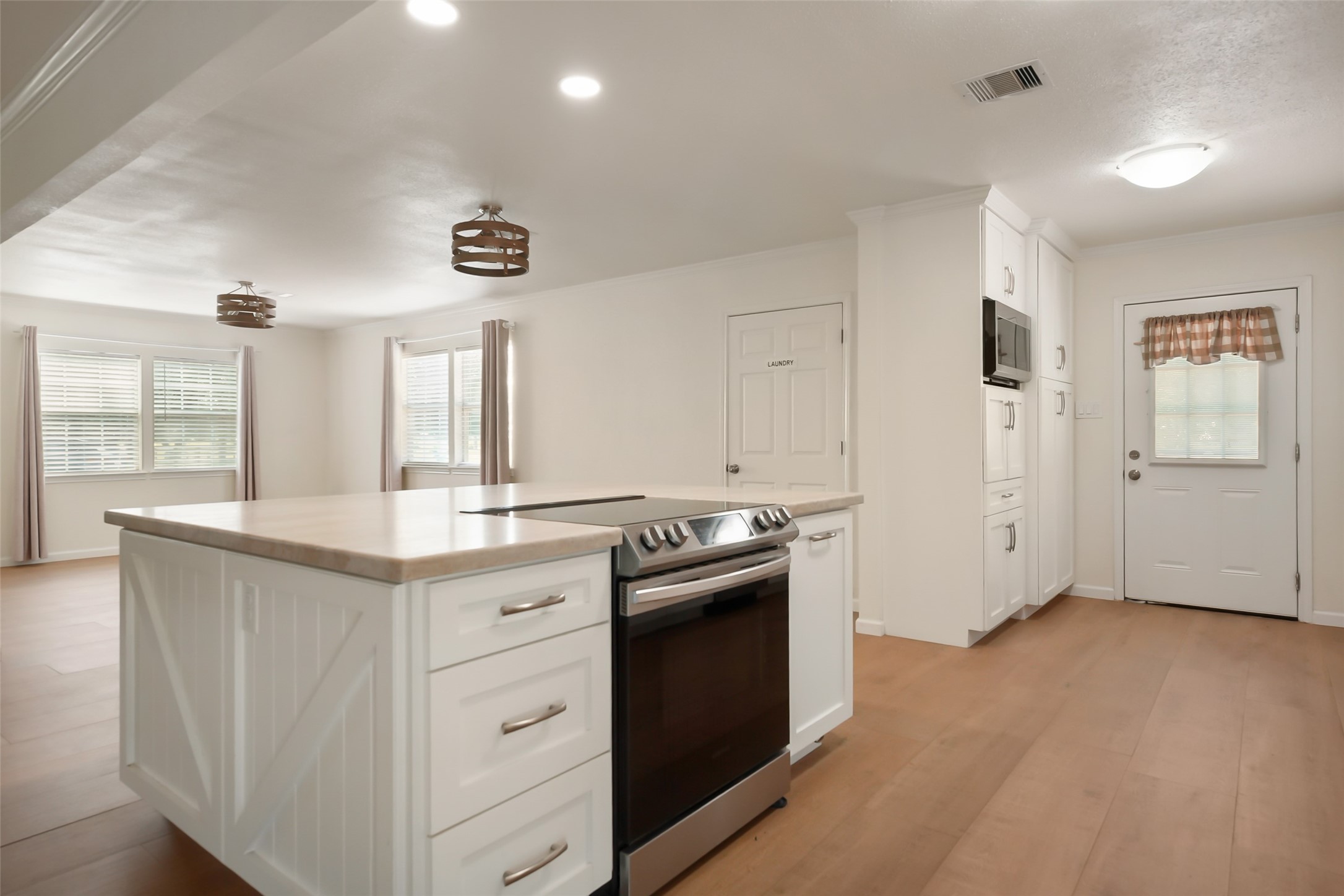 19635 Kermier Road Waller, TX 77484 - Photo 25 of 27 Functional kitchen with a center island, stainless steel appliances, and ample workspace.