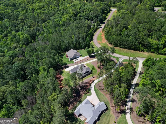 an aerial view of a house with a yard and outdoor seating