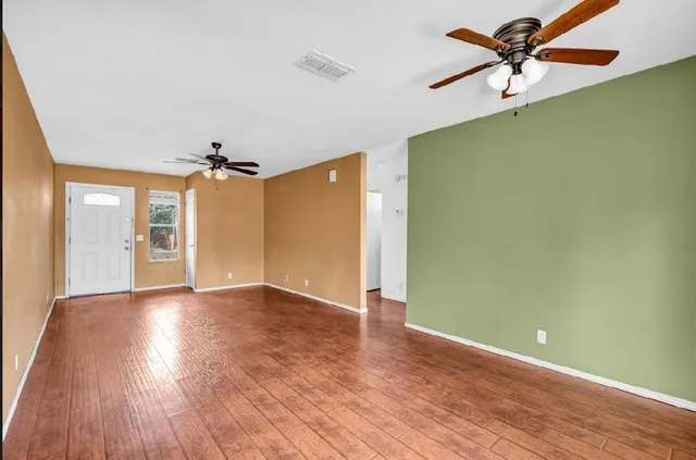 wooden floor in an empty room with a window
