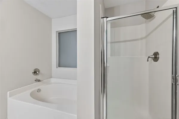 a bathroom with a white bath tub and a shower