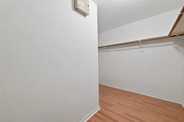 a view of a room with wooden floor