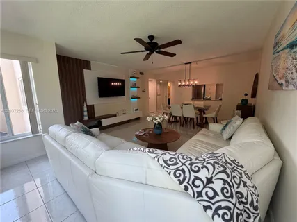 a kitchen with stainless steel appliances granite countertop a refrigerator a stove and a sink