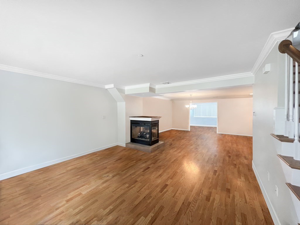 216 Rangeway Road, Unit 173 Billerica, MA 01862 - Photo 2 of 7 a view of empty room with wooden floor and fireplace