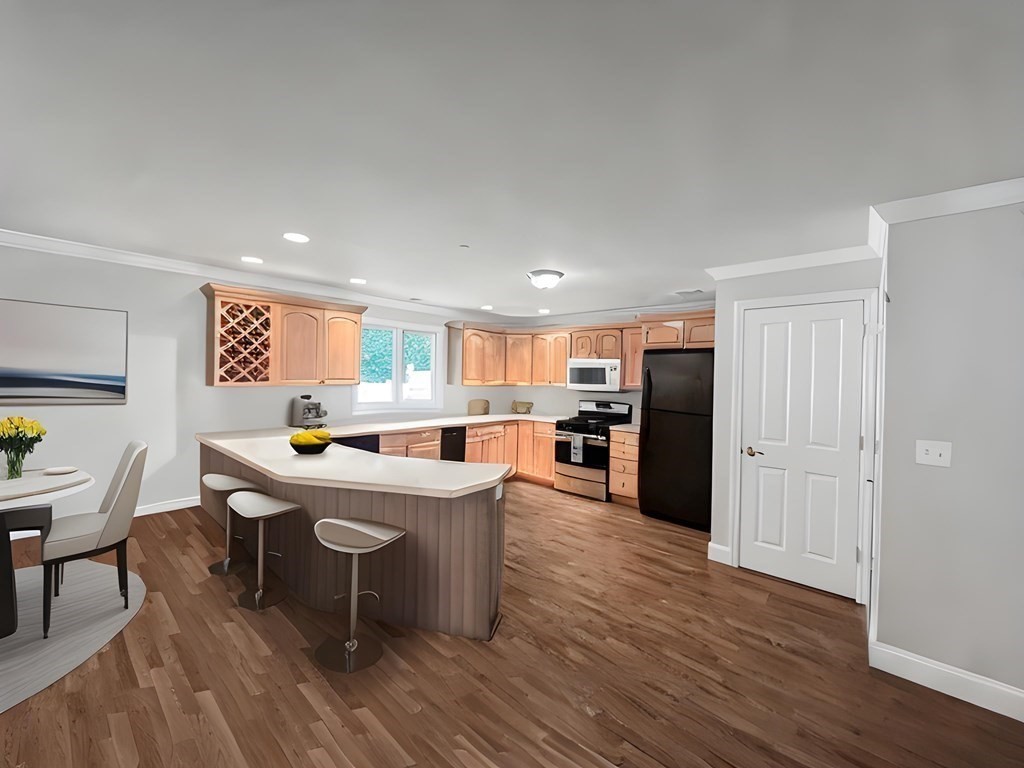 216 Rangeway Road, Unit 173 Billerica, MA 01862 - Photo 5 of 7 a room with stainless steel appliances kitchen island granite countertop a table chairs and a refrigerator