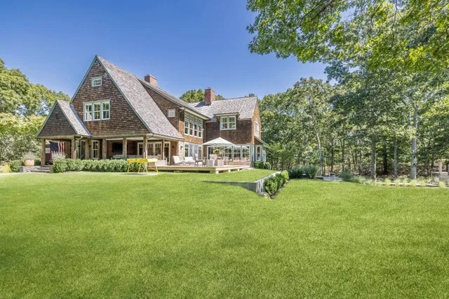 a view of an house with backyard space and garden