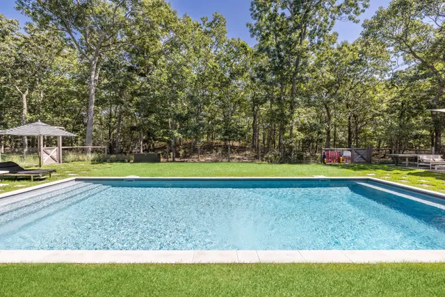 a patio with a table and chairs under an umbrella