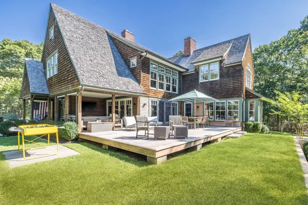 a view of a house with a yard porch and sitting area