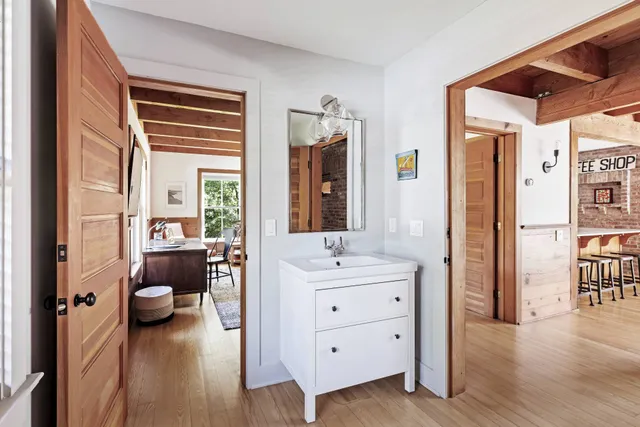 a bathroom with a double vanity sink a mirror and a bathtub