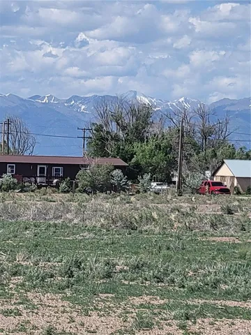 a view of a house with a yard and sitting area
