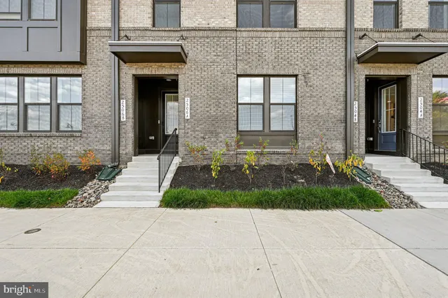 a front view of a brick house with a yard