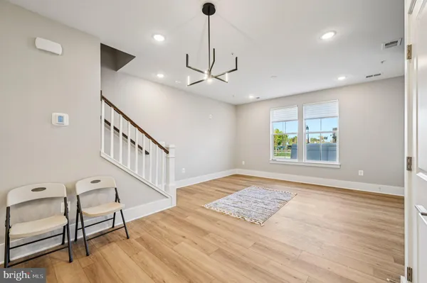 a view of an empty room window and wooden floor