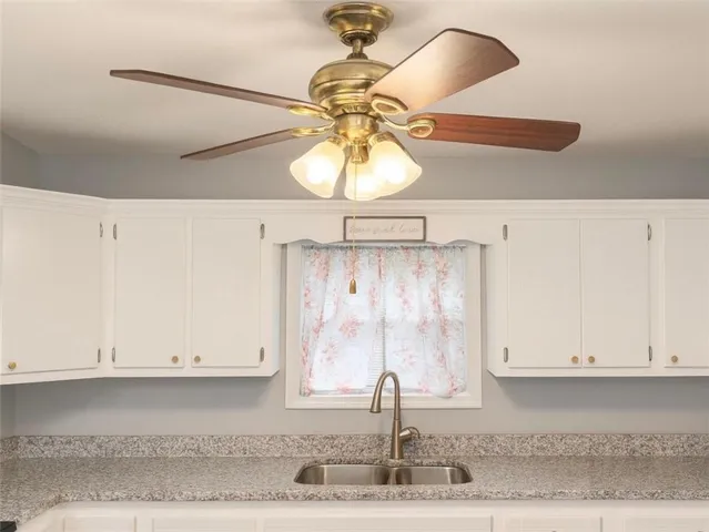 a bathroom with a sink and cabinets