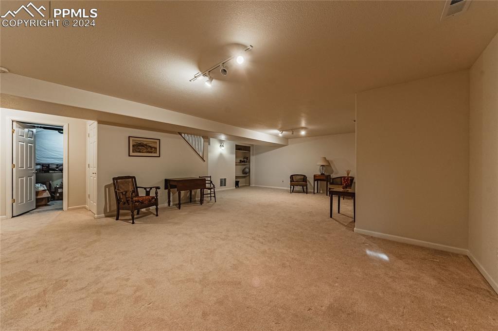 5148 Peak Villa Heights Colorado Springs, CO 80917 - Photo 29 of 45 Basement family room and access to storage room.