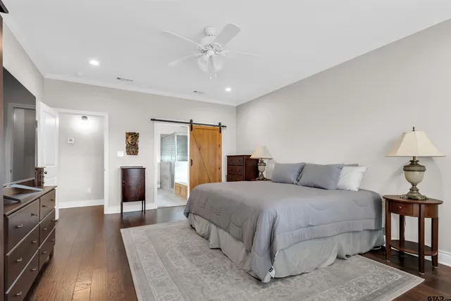 a bedroom with a large bed and a chandelier
