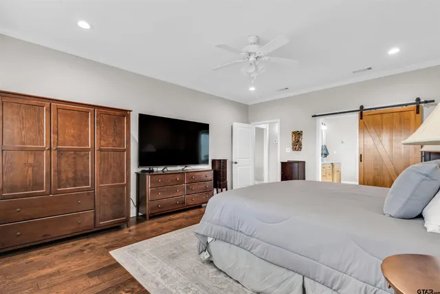 a bedroom with a bed and flat screen tv