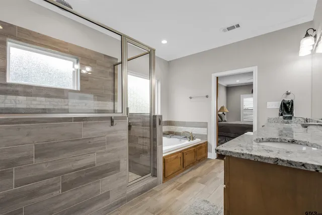 a bathroom with a granite countertop sink and a mirror