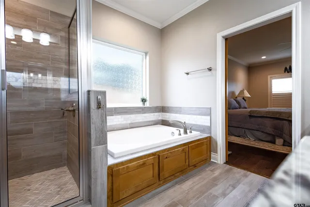 a spacious bathroom with a tub a double vanity sink and a large mirror