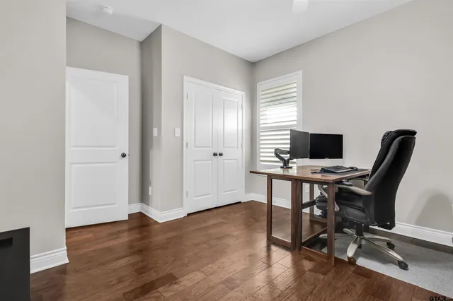 a view of a workspace with furniture and wooden floor