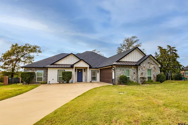 a front view of a house with a garden