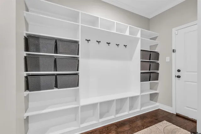 a view of walk in closet with empty racks