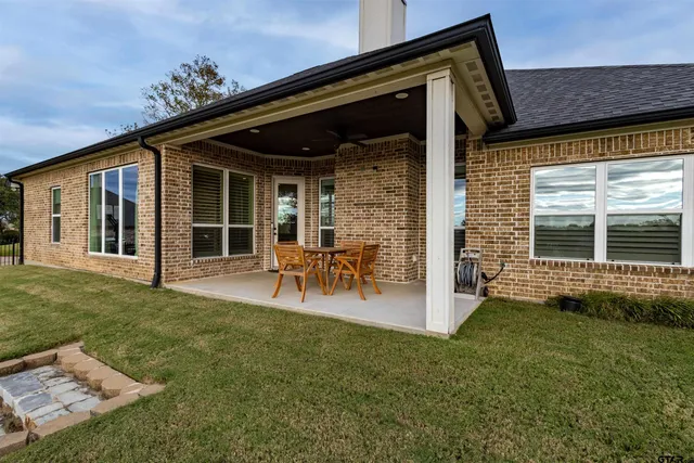 a view of a porch with chairs and backyard