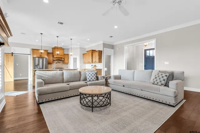 a living room with furniture and a chandelier