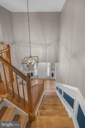 a spacious bedroom with a bed and a chandelier