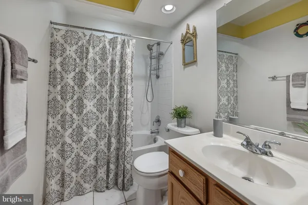 a bathroom with a sink toilet and a mirror