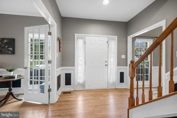 a view of a livingroom with wooden floor and furniture