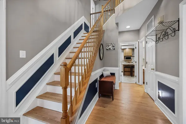 a view of staircase with lots of frames and a rug