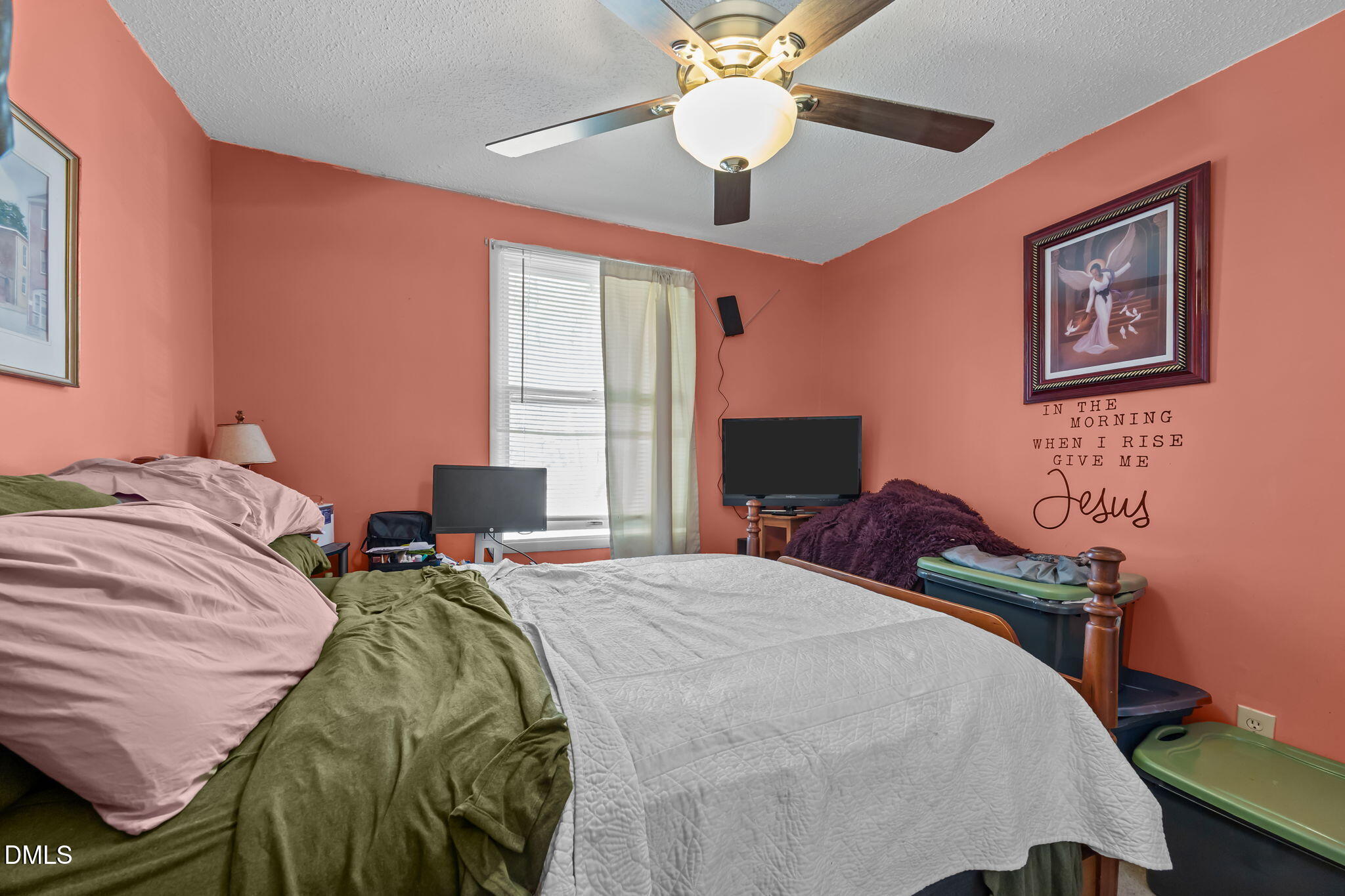 7740 Sandra Lane Raleigh, NC 27615 - Photo 16 of 36 a bedroom with a bed and a chandelier