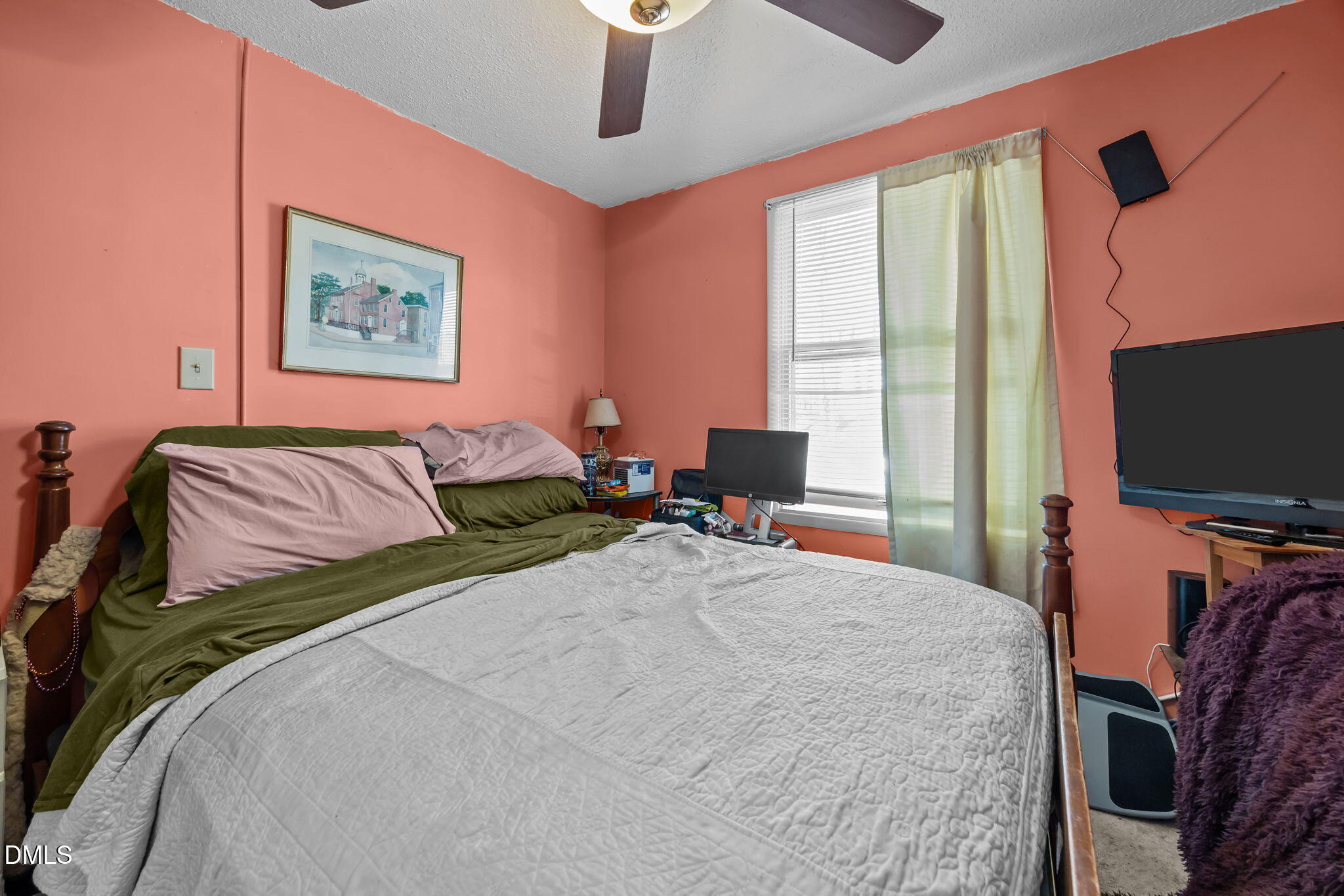 7740 Sandra Lane Raleigh, NC 27615 - Photo 17 of 36 a bedroom with a bed and a flat screen tv