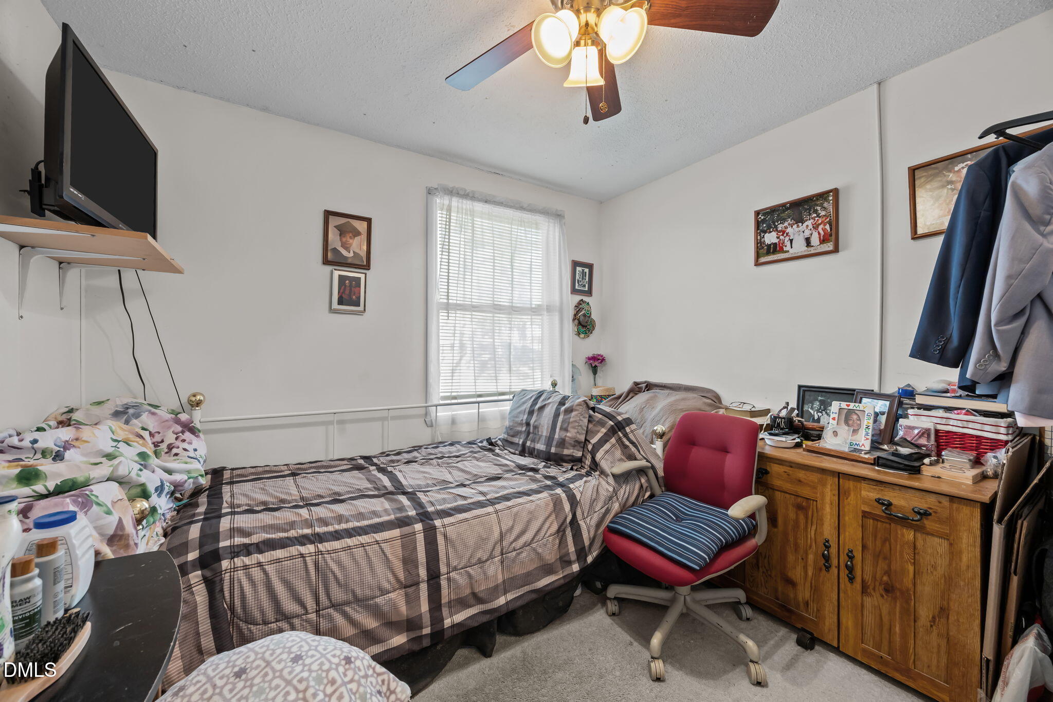 7740 Sandra Lane Raleigh, NC 27615 - Photo 21 of 36 a bedroom with furniture and a flat screen tv