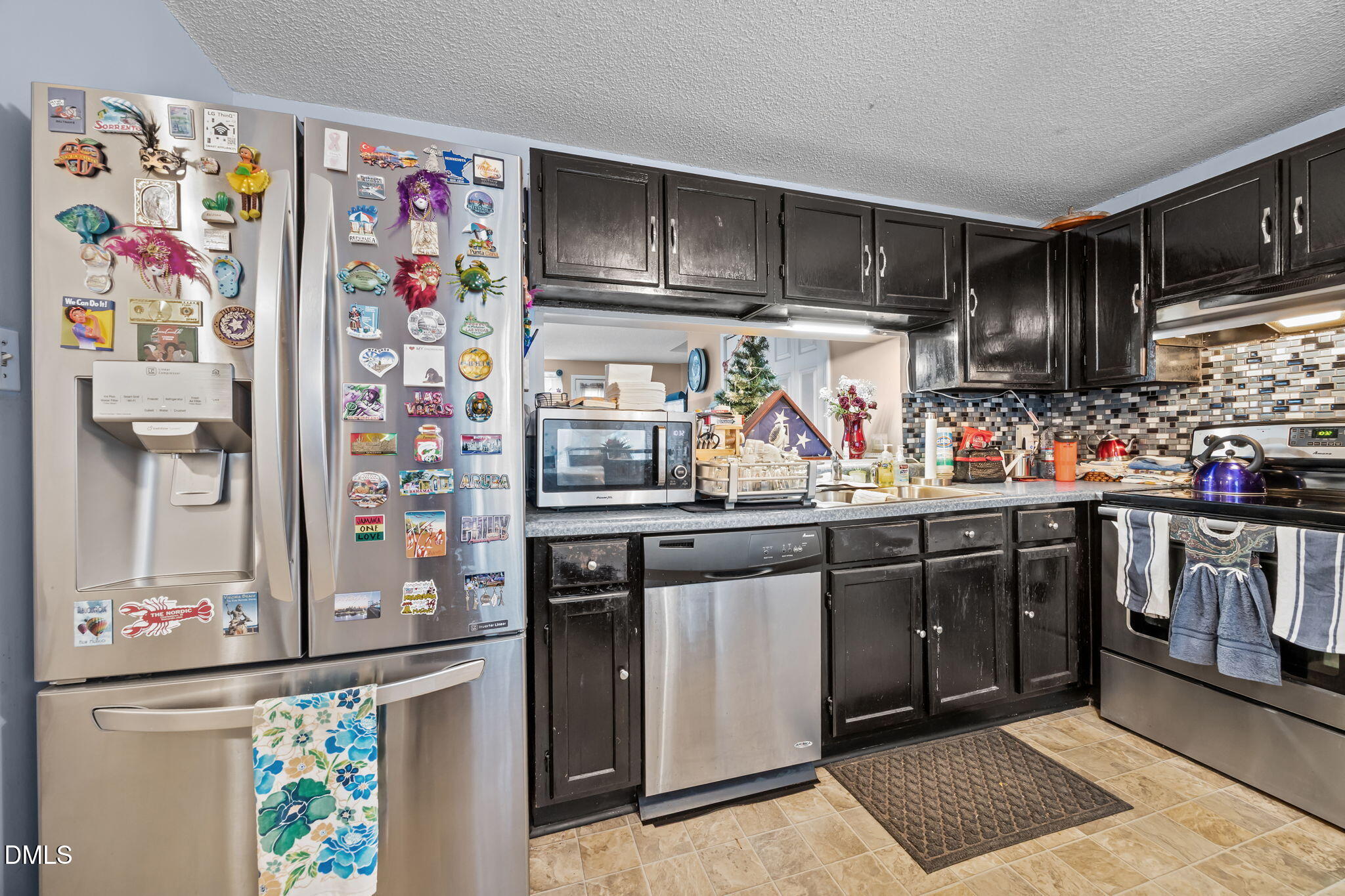 7740 Sandra Lane Raleigh, NC 27615 - Photo 5 of 36 a kitchen with lots of counter top space and stainless steel appliances