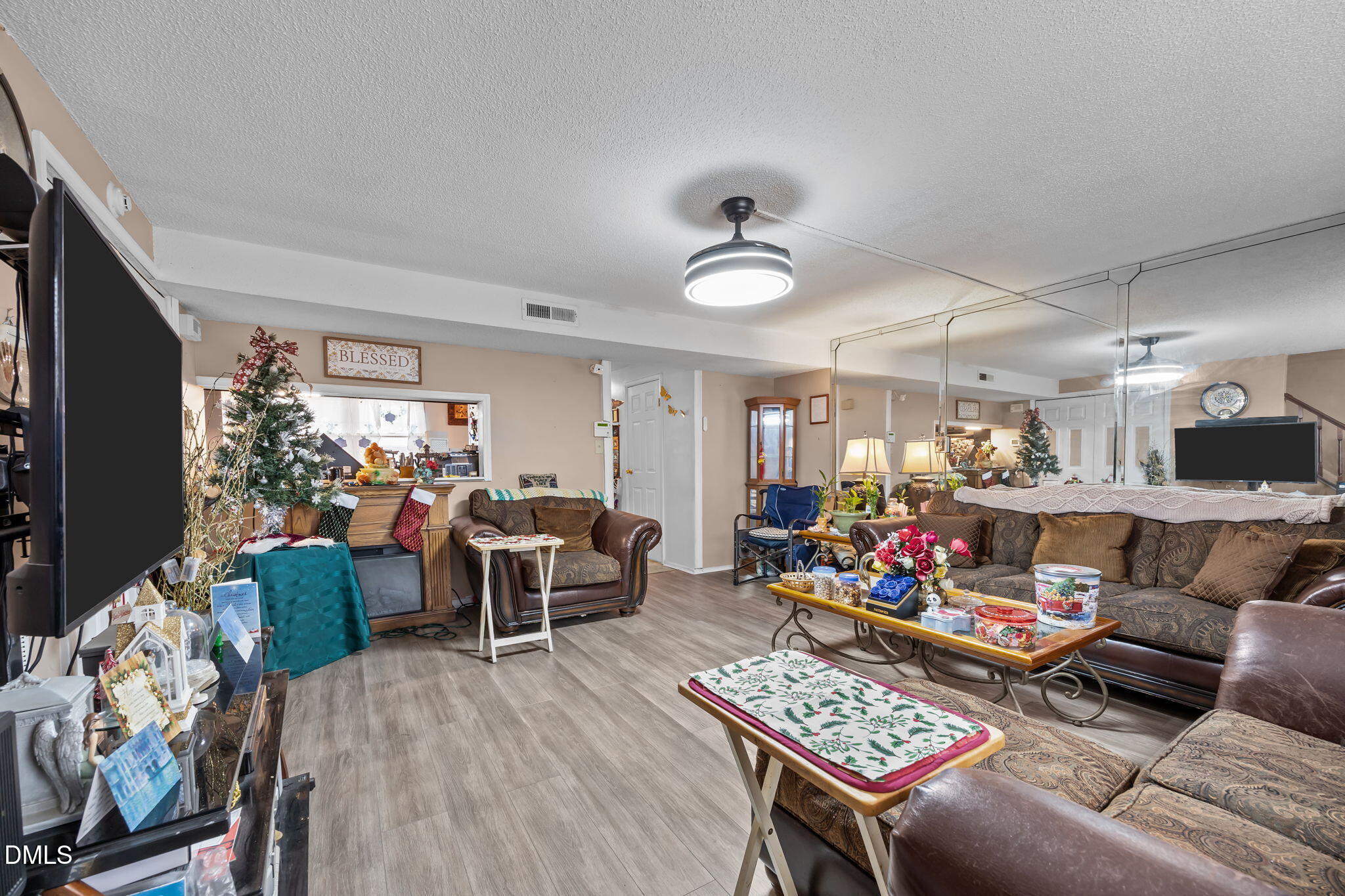 7740 Sandra Lane Raleigh, NC 27615 - Photo 9 of 36 a living room with furniture and a flat screen tv