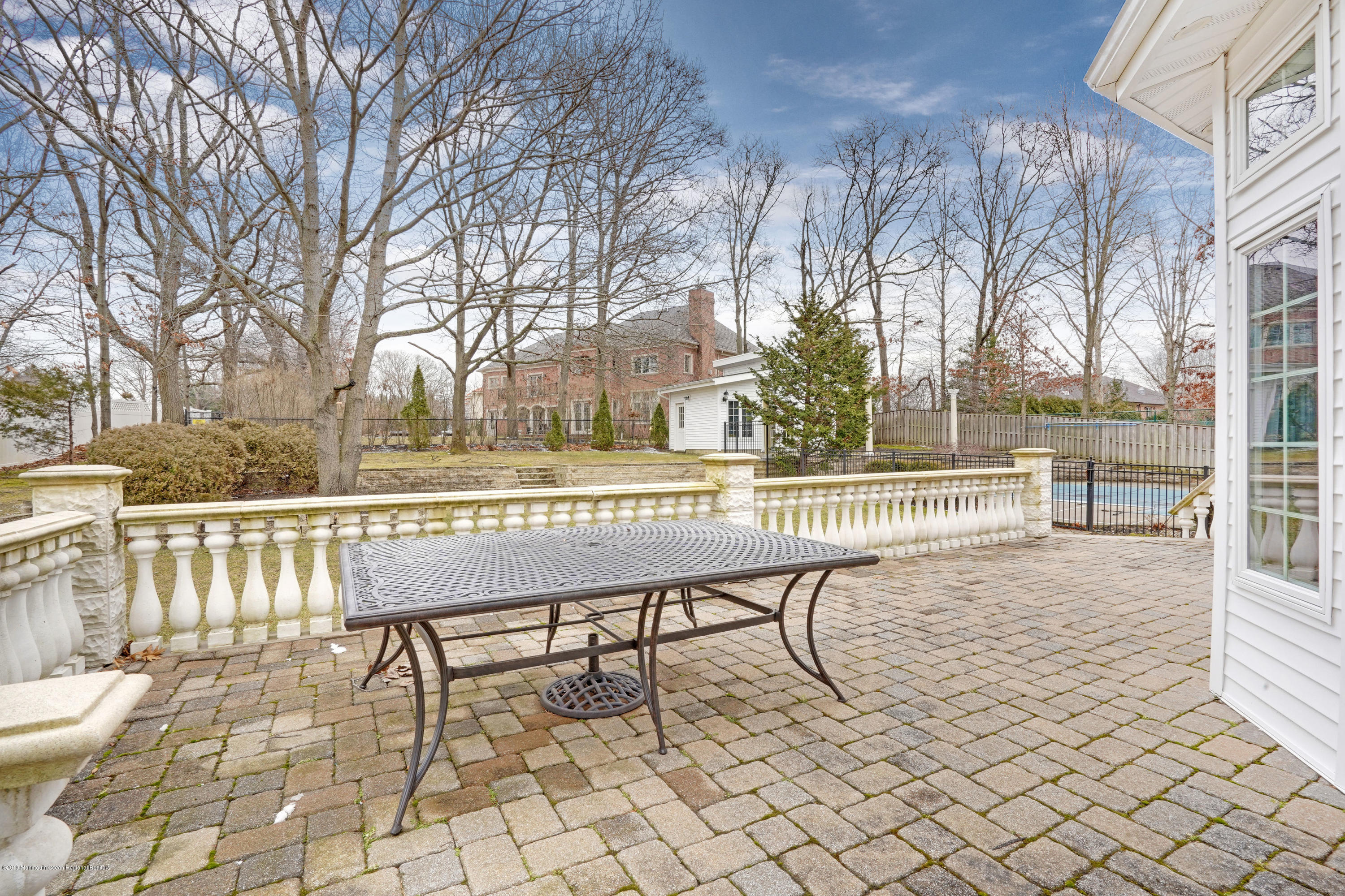 90 Georgetown Road Eatontown, NJ 07724 - Photo 16 of 18 a porch with a bench and trees