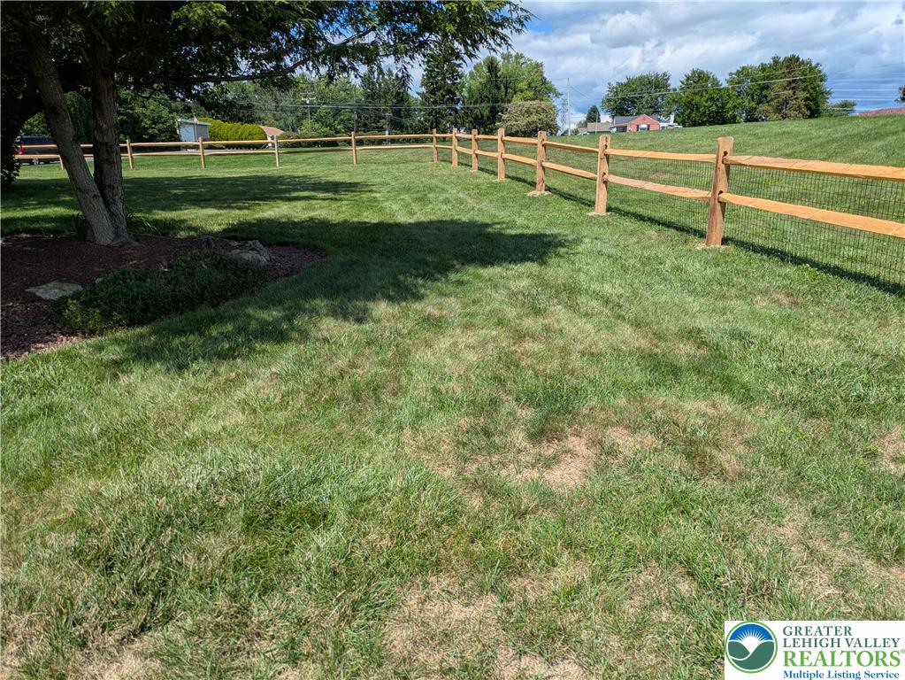 3285 Cherryville Road Northampton, PA 18067 - Photo 51 of 51 Mature shade trees and a classic split-rail fence frame this expansive grassy lawn.