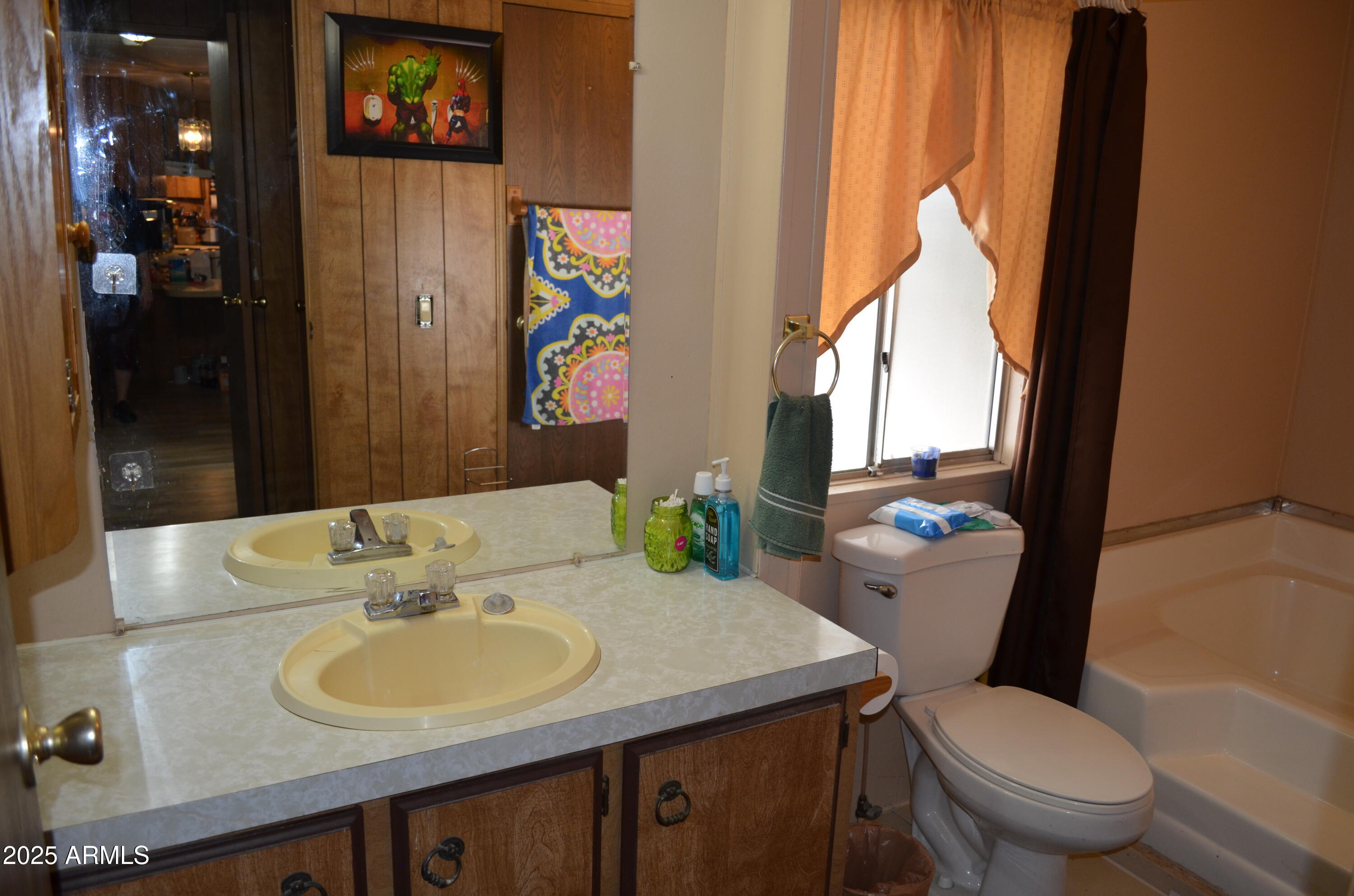 318 South Crismon Road, Unit 24 Mesa, AZ 85208 - Photo 14 of 23 a bathroom with a toilet sink and mirror