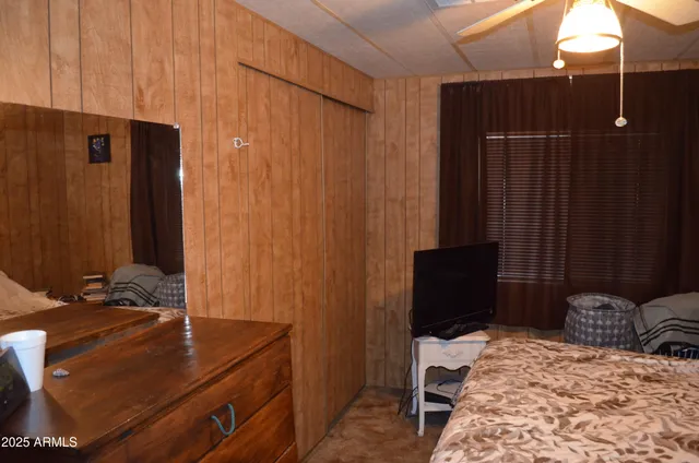 a room with a bed and a dresser