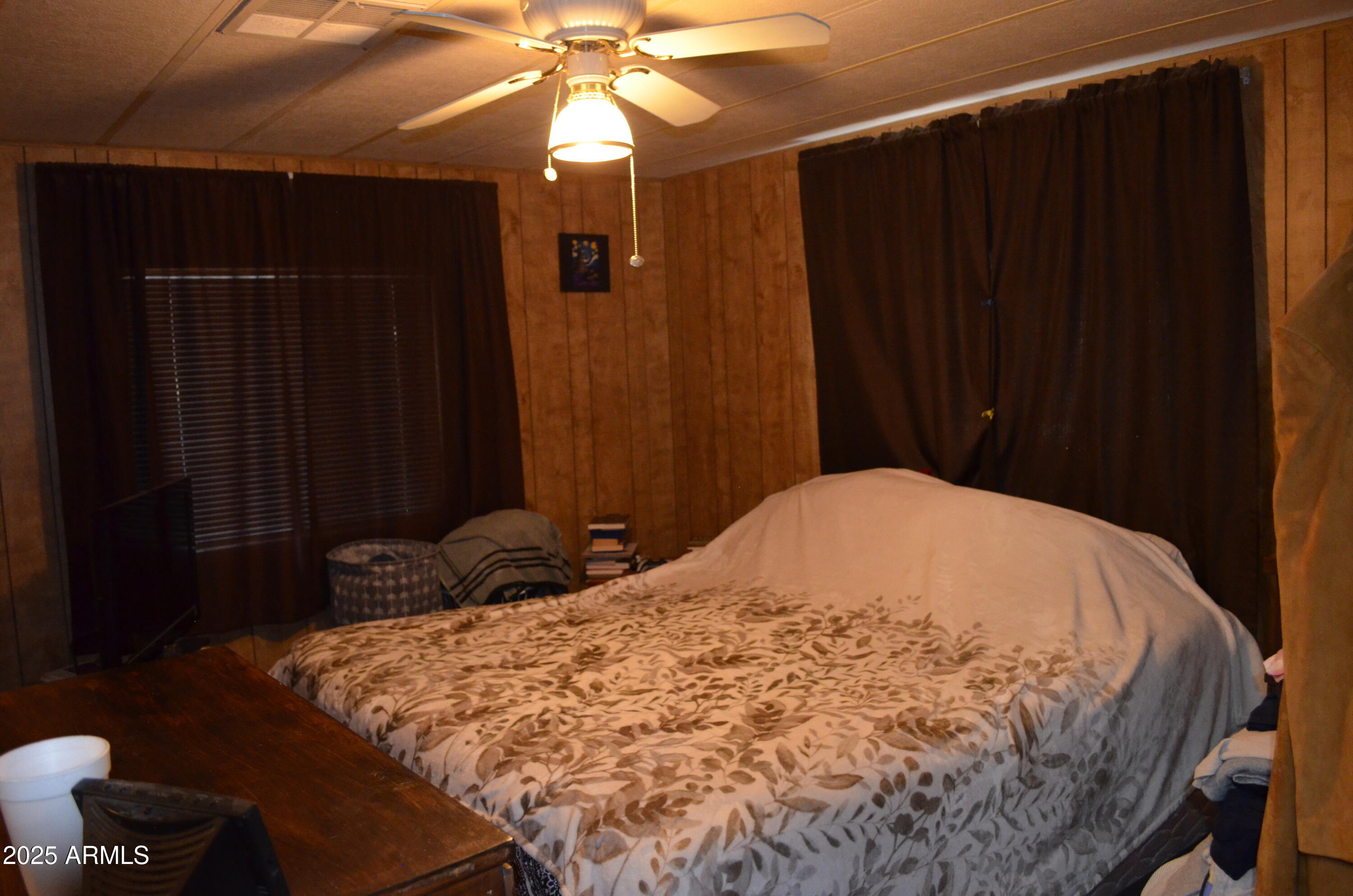 318 South Crismon Road, Unit 24 Mesa, AZ 85208 - Photo 16 of 23 a bedroom with a bed and a chandelier