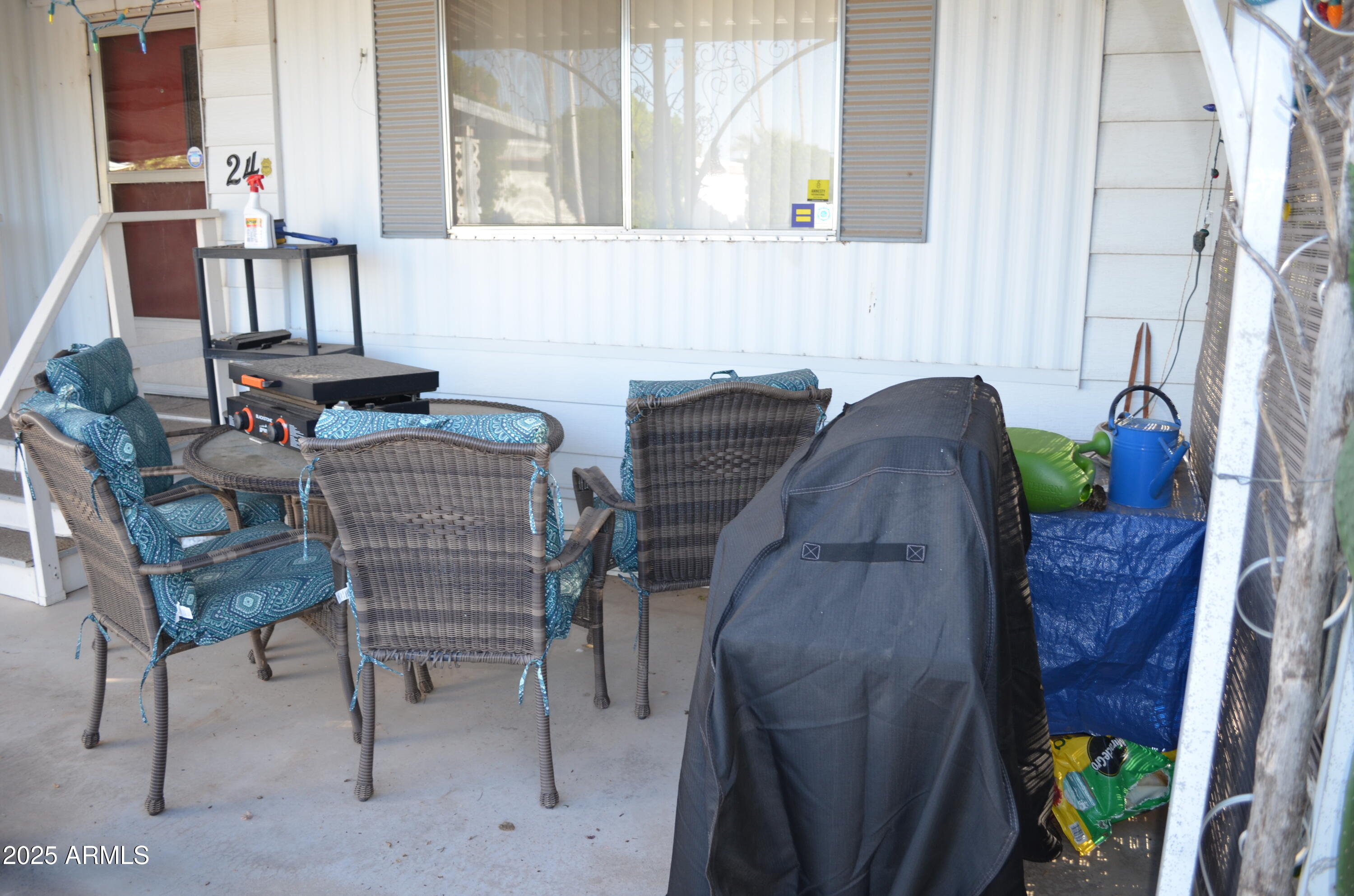 318 South Crismon Road, Unit 24 Mesa, AZ 85208 - Photo 22 of 23 a view of a dining room with furniture and a potted plant