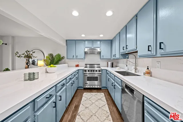 a kitchen with a sink stove and cabinets
