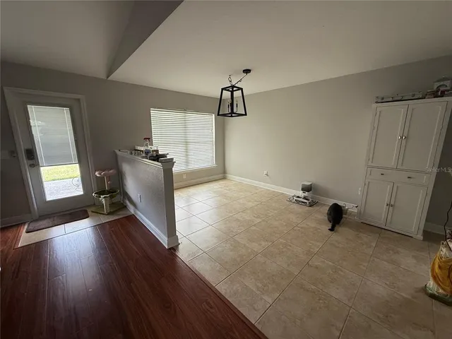a view of a room with wooden floor and windows
