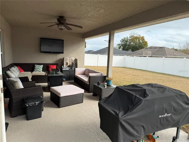 a living room with furniture and a floor to ceiling window