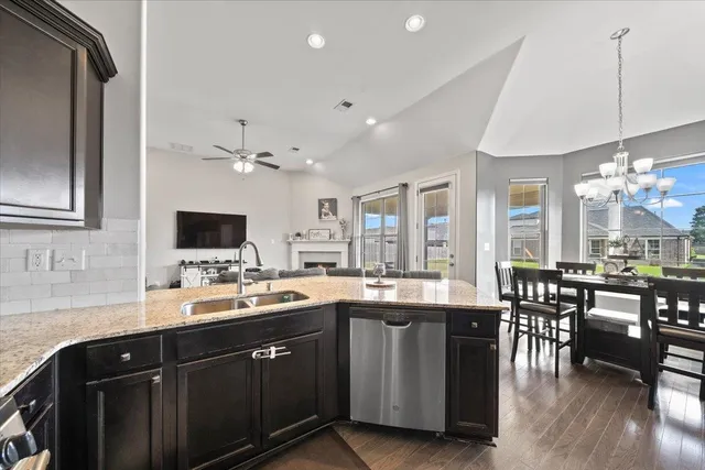 a kitchen with lots of counter top space and dining table