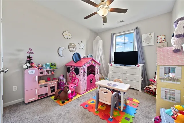 a bedroom with furniture and a flat screen tv