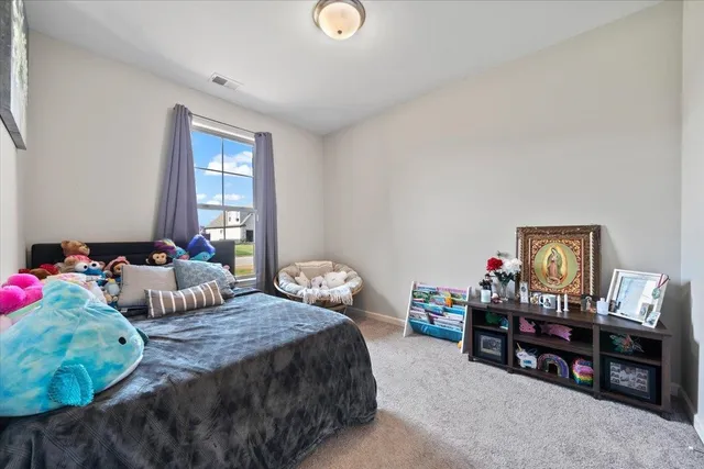 a bedroom with bed and a large window