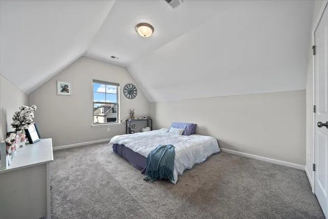 a spacious bedroom with a bed and window