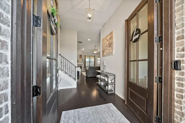 a view of entryway and hall with wooden floor